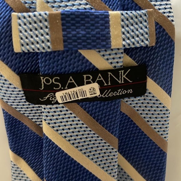Jos A Bank men’s tie in various blues and metallic gold and tan stripes. NWT - Picture 3 of 4